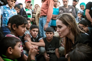 This June 18, 2013 photo released by the United Nations High Commissioner for Refugees (UNHCR) shows special envoy Angelina Jolie, right, speaking with Syrian refugees in a Jordanian military camp based near the Syria-Jordan border. The Syrian civil war contributed to pushing the numbers of refugees and those displaced by conflict within their own nation to an 18-year high of 45.2 million worldwide by the end of 2012, the U.N. refugee agency said Wednesday, June 19. Most of the refugees in the world have fled from five war-affected countries: Afghanistan, Somalia, Iraq, Syria and Sudan. (AP Photo/United Nations High Commissioner for Refugees , O. Laban-Matte)